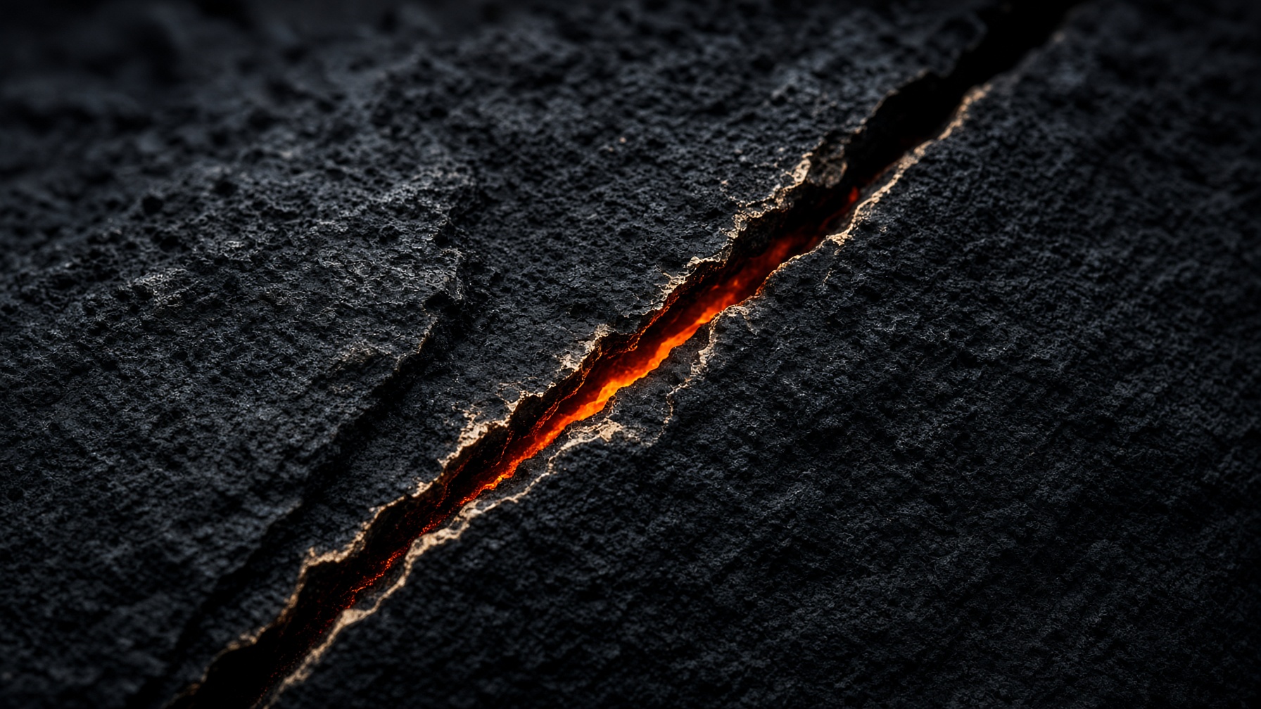 Black stone split by a thin ember fissure
