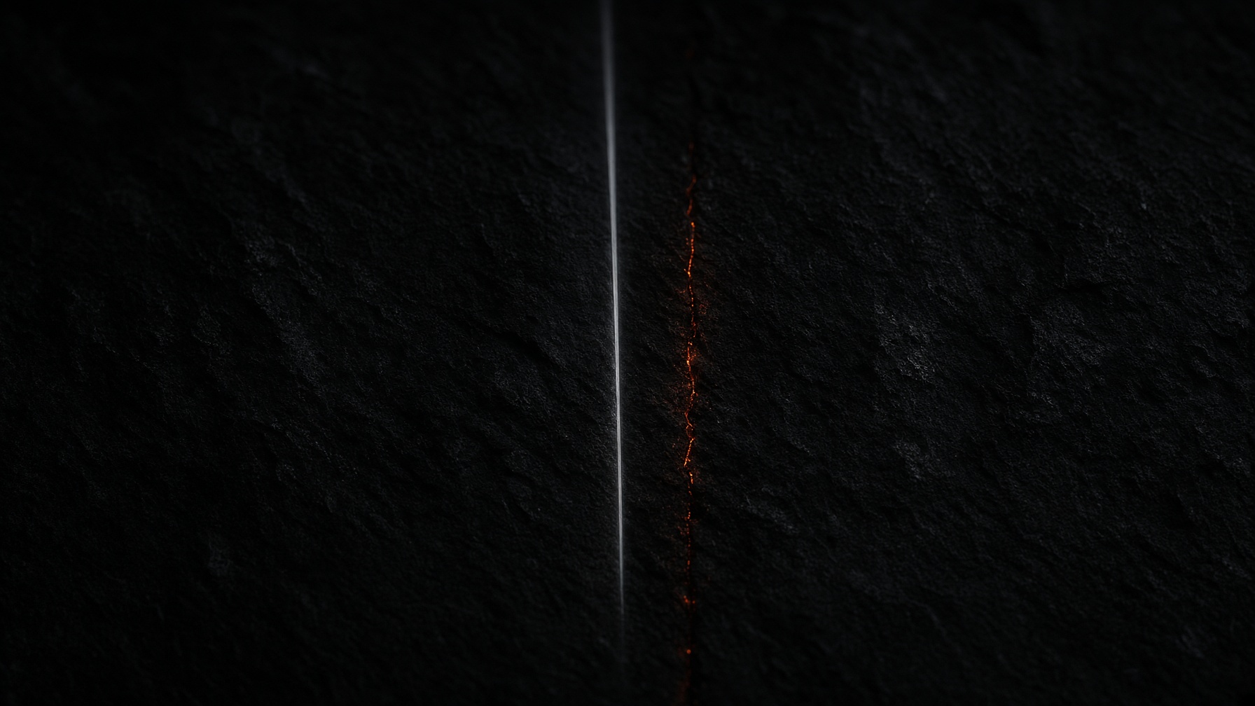 Black stone cut by a single vertical line of pale light